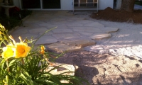 screening installed below flagstone for stability